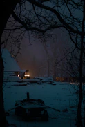 An outdoor shot of a rustic cabin at dusk, soft shadows casting a peaceful mood.