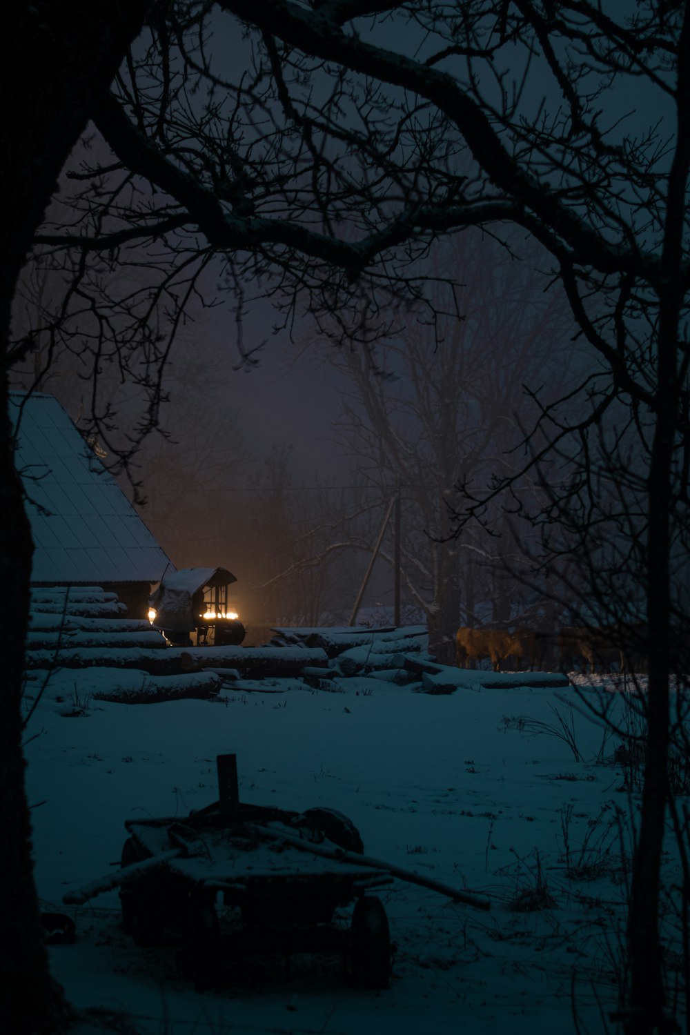 a tractor is parked in the snow at night