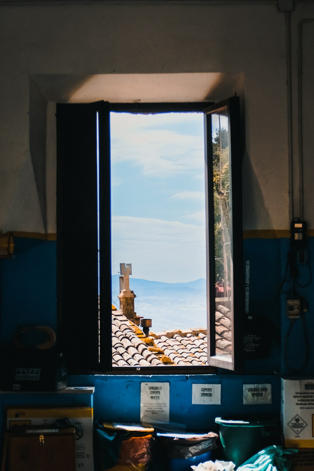 an open window with a view of the ocean