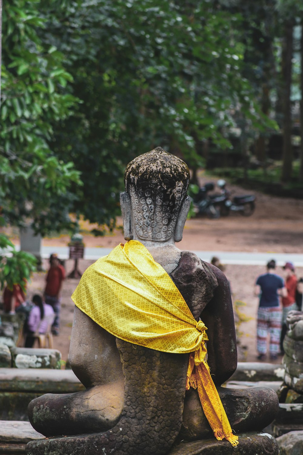 a statue of a man with a yellow scarf around his neck