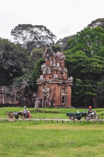 a couple of people riding on the back of a motorcycle