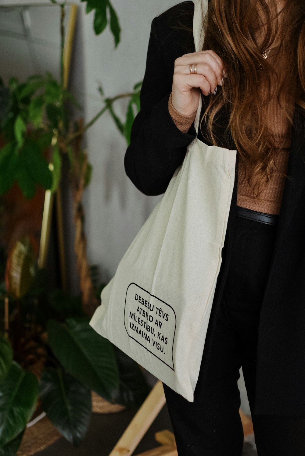 a woman holding a bag with a message on it