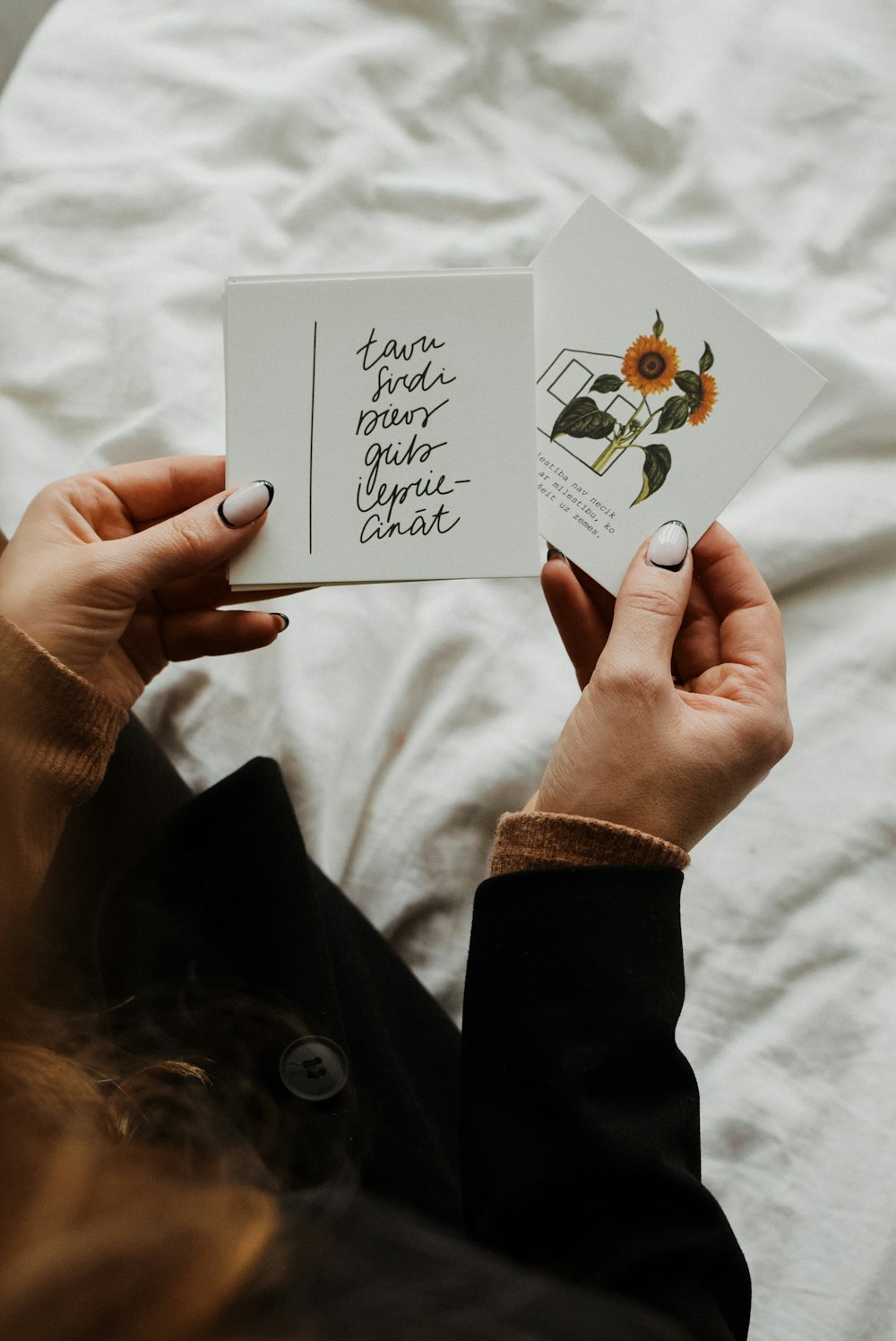 a woman holding two cards with a quote on them