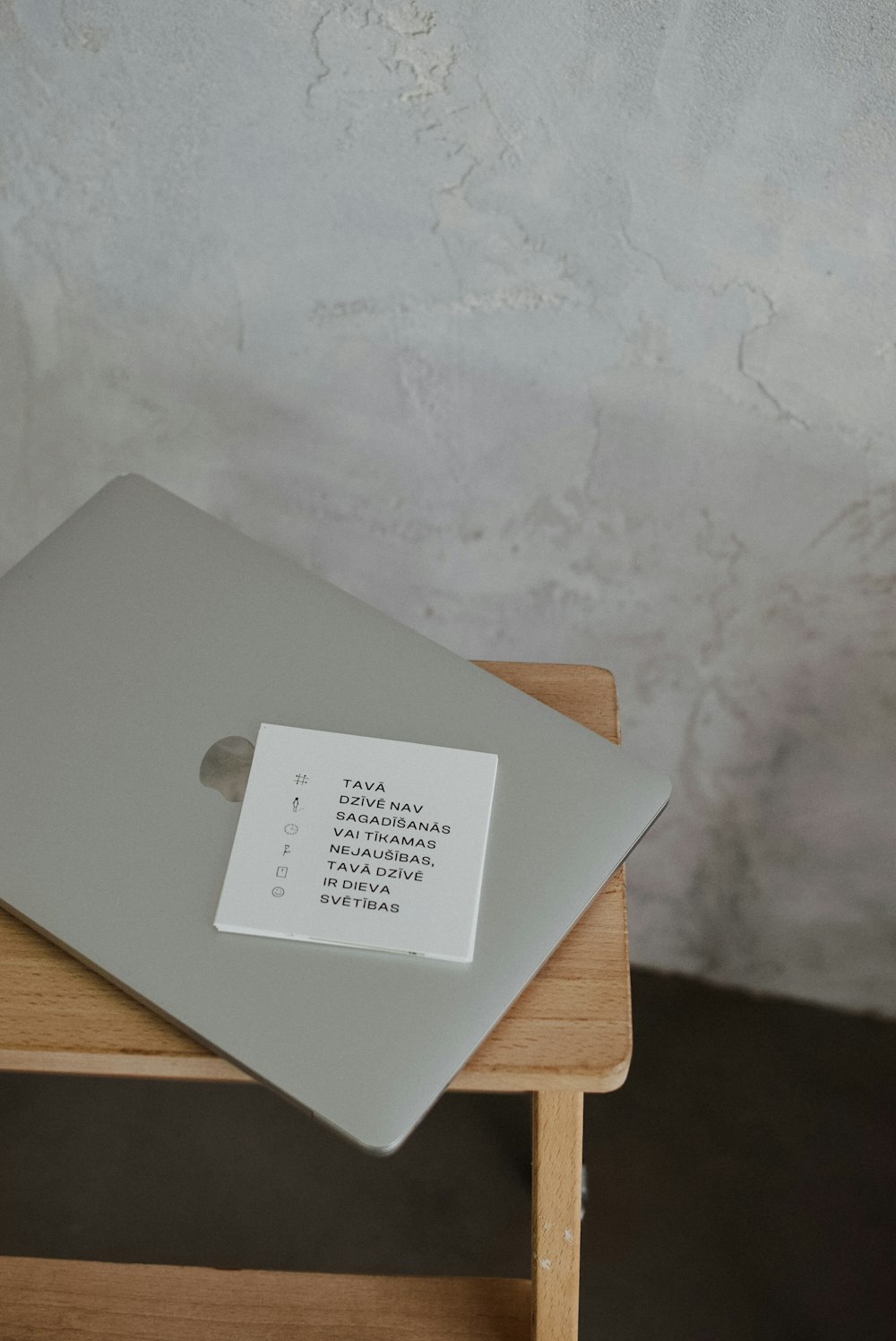 a laptop computer sitting on top of a wooden table