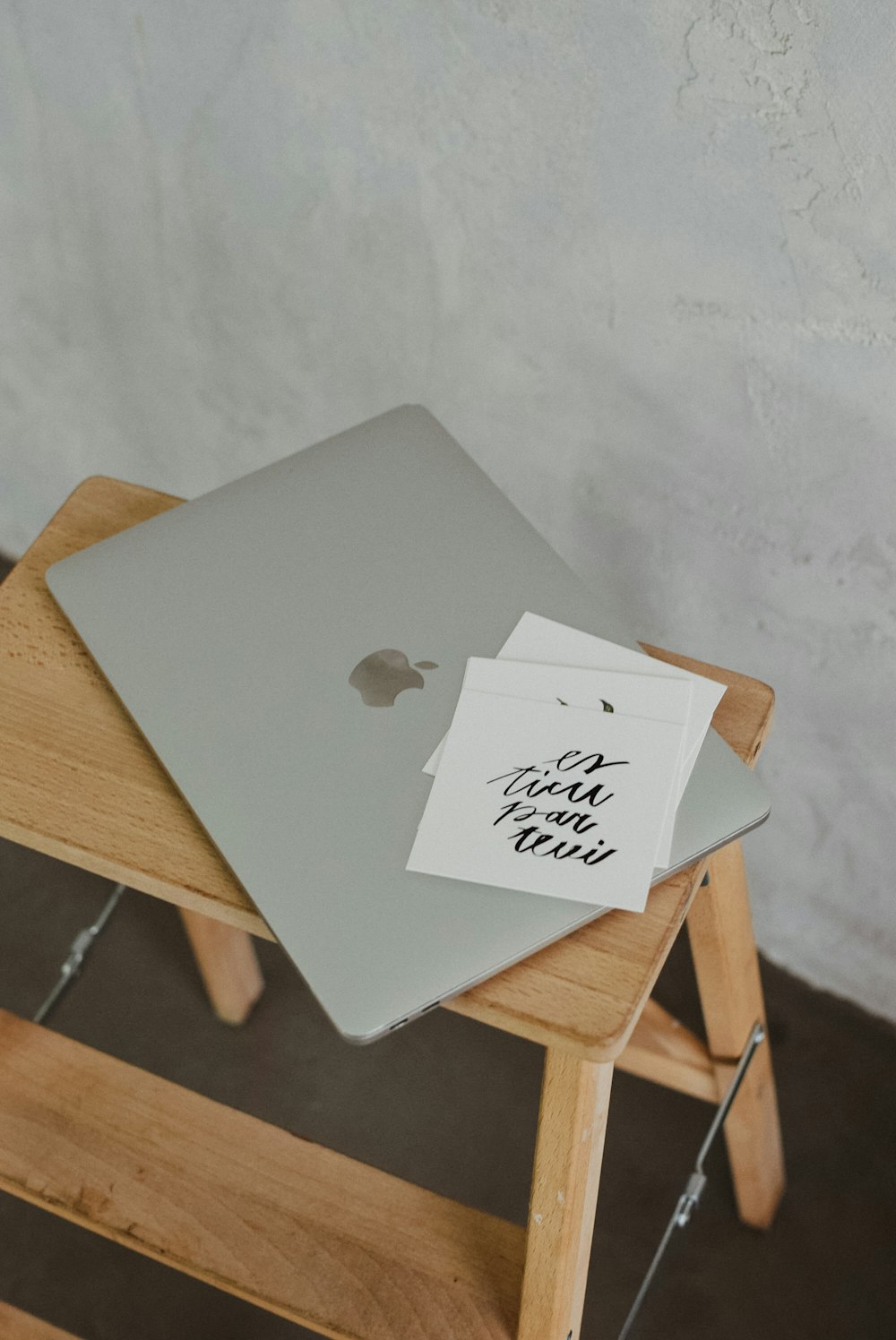 a laptop computer sitting on top of a wooden table