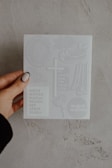 A close-up of hands holding a prayer request card with hopeful messages.