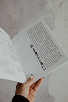 a person holding a book in their hand