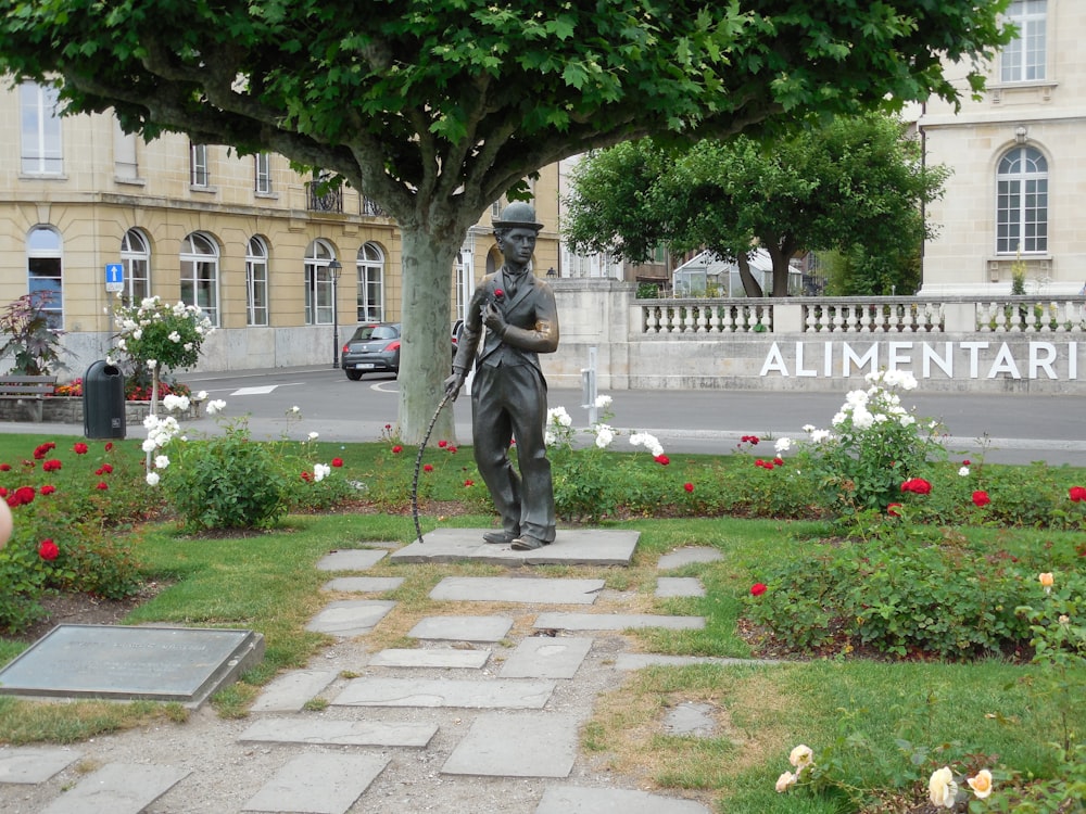 a statue of a man holding a rifle in a garden