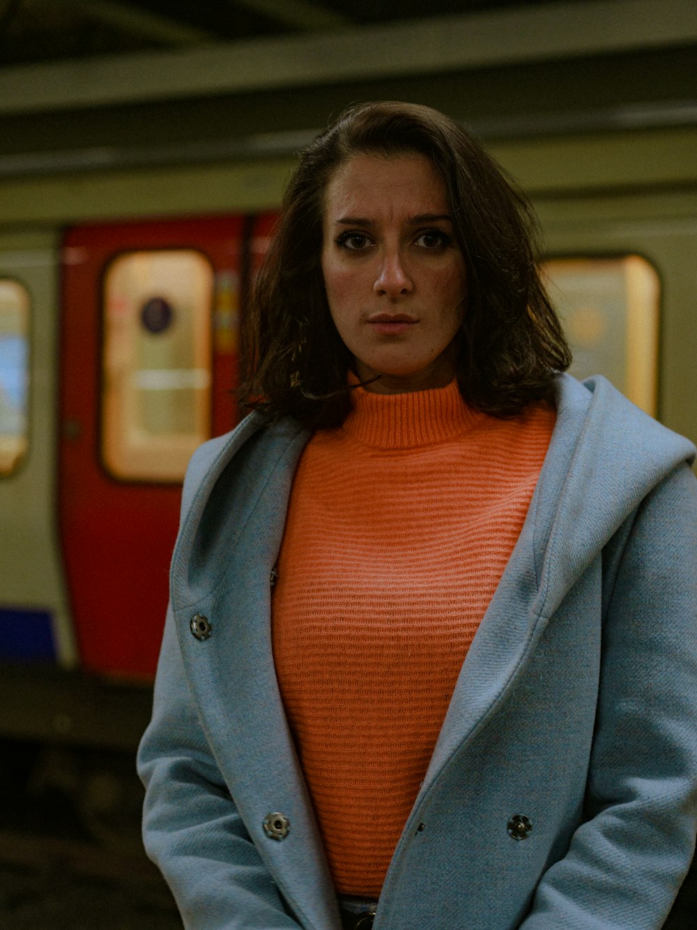 a woman standing in front of a train