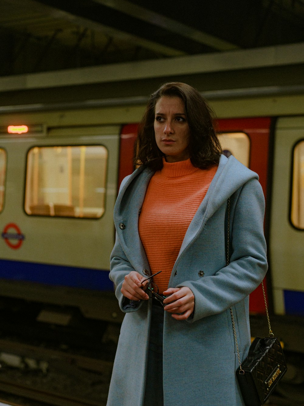 a woman standing in front of a train