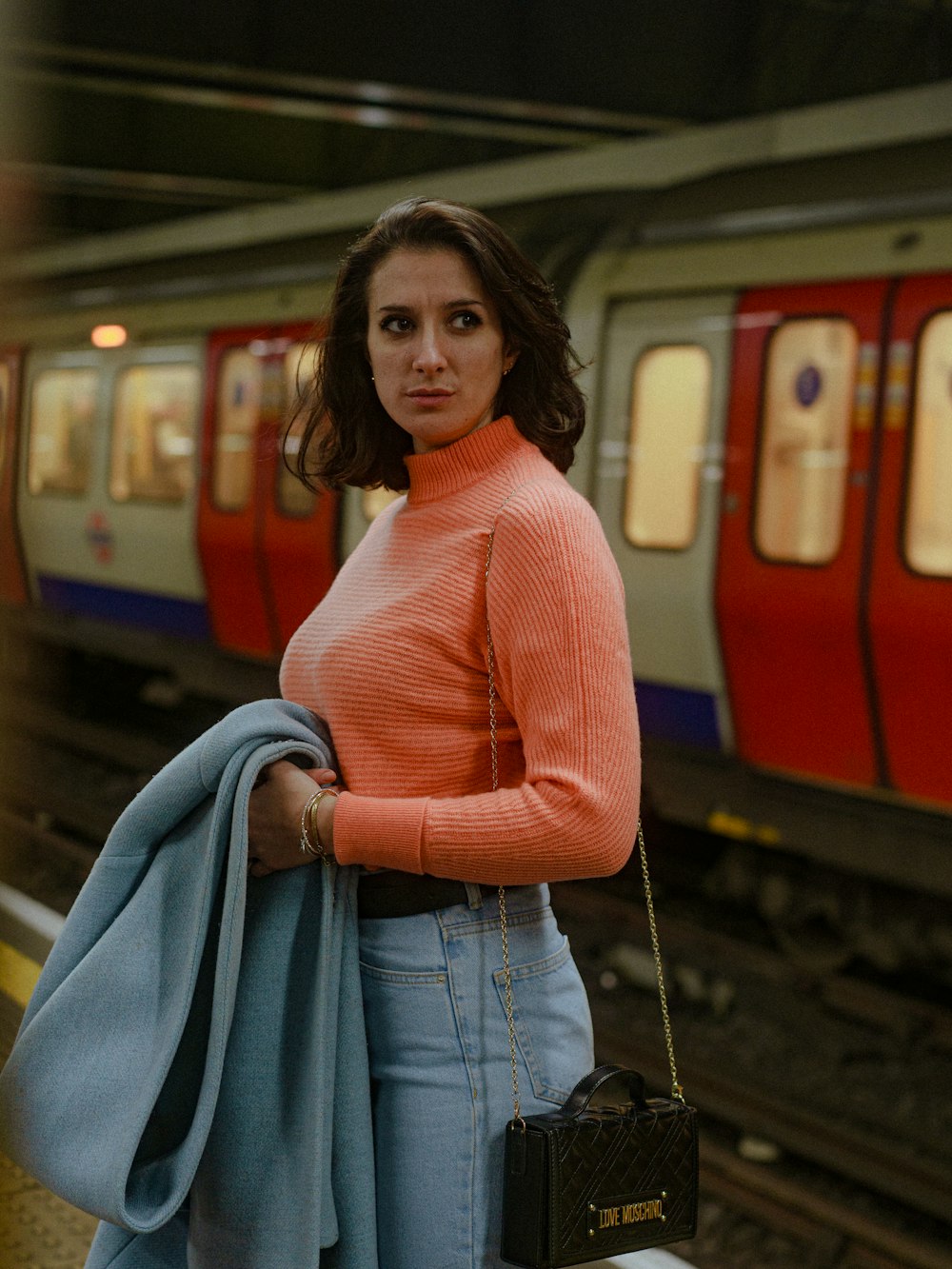 a woman standing in front of a train