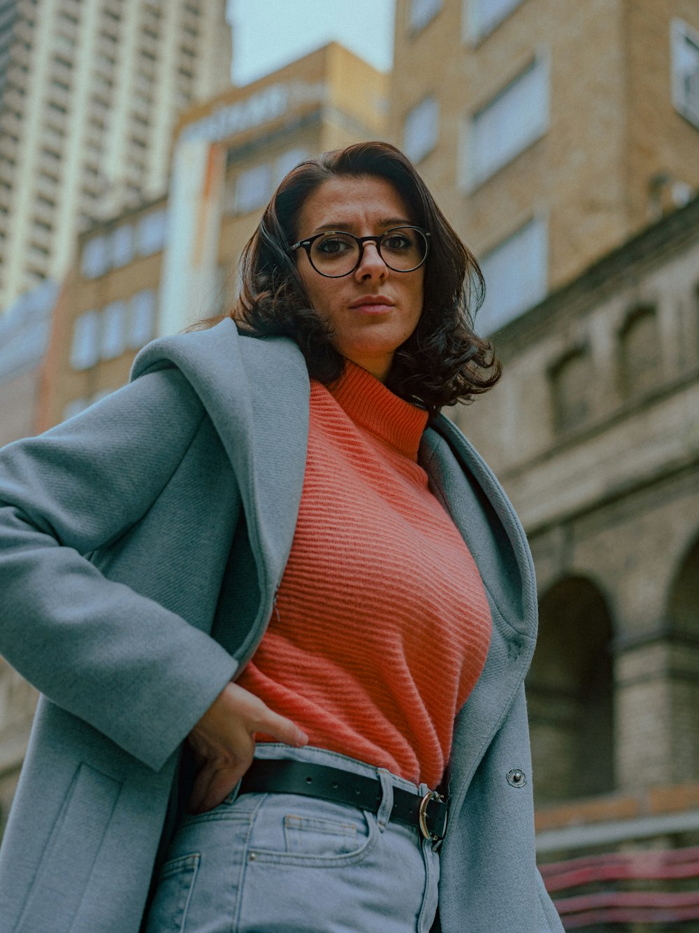 a woman in a red sweater and blue coat