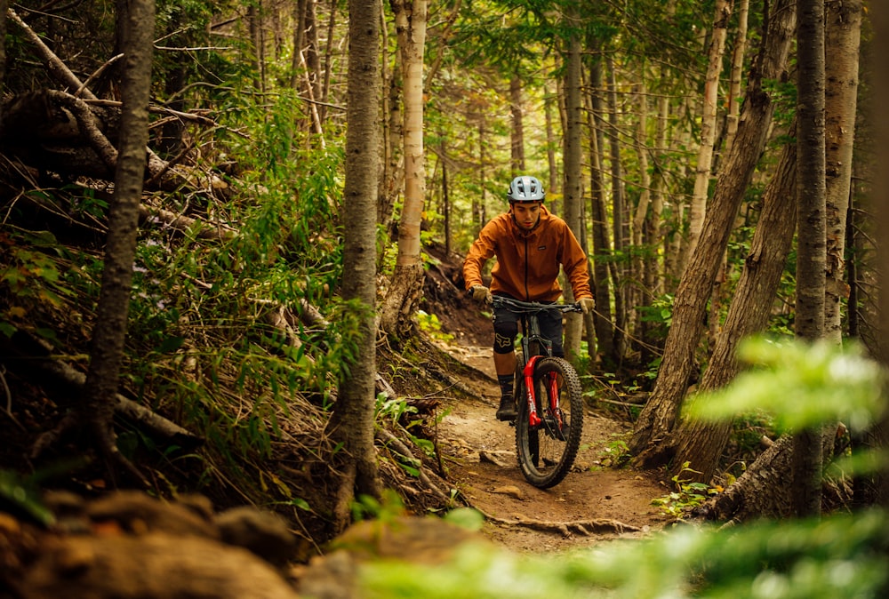 a man riding a mountain bike through a forest