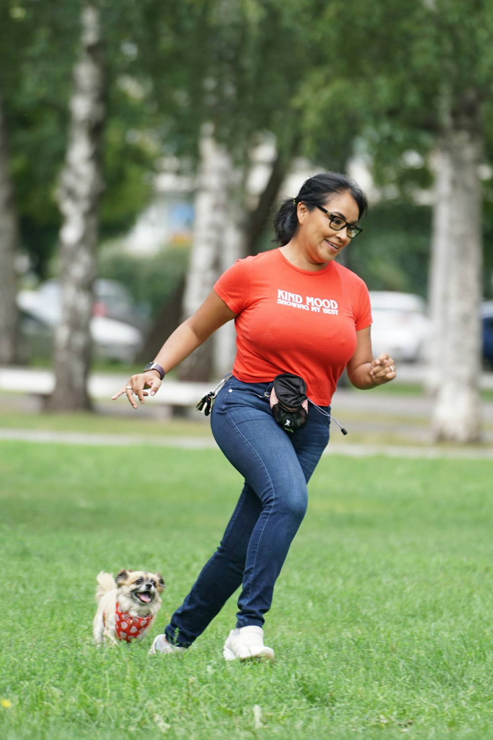a woman running with a dog in a park