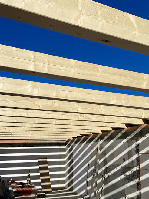 Framing work in progress highlighting sturdy wooden beams and precise cuts