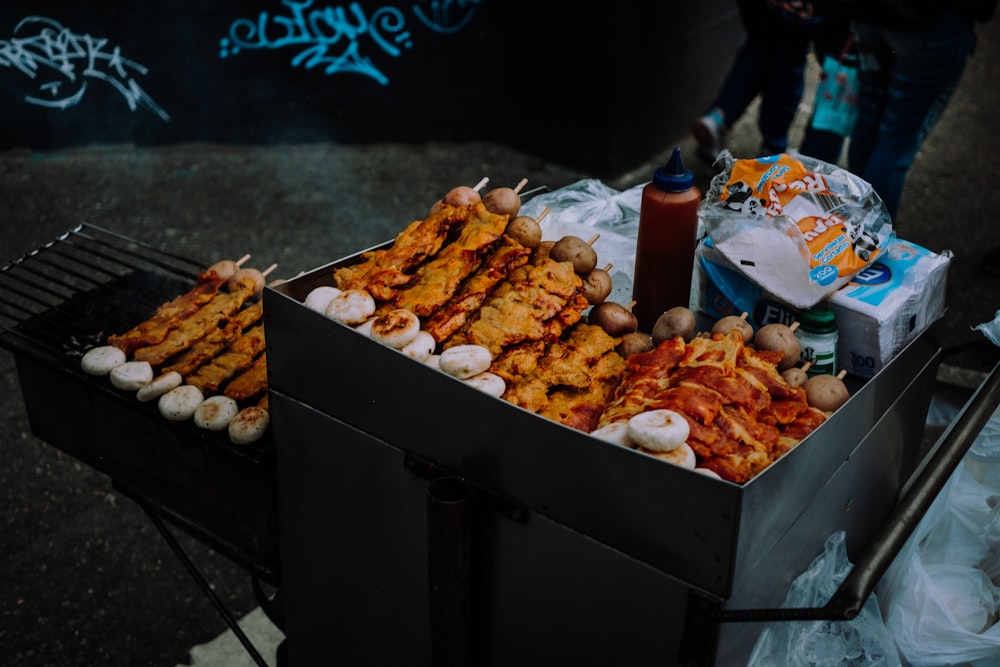 a box of food sitting on top of a grill