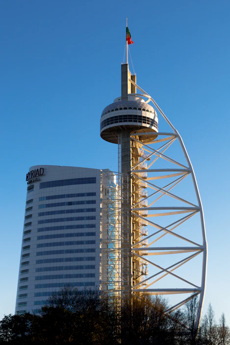 a tall tower with a flag on top of it