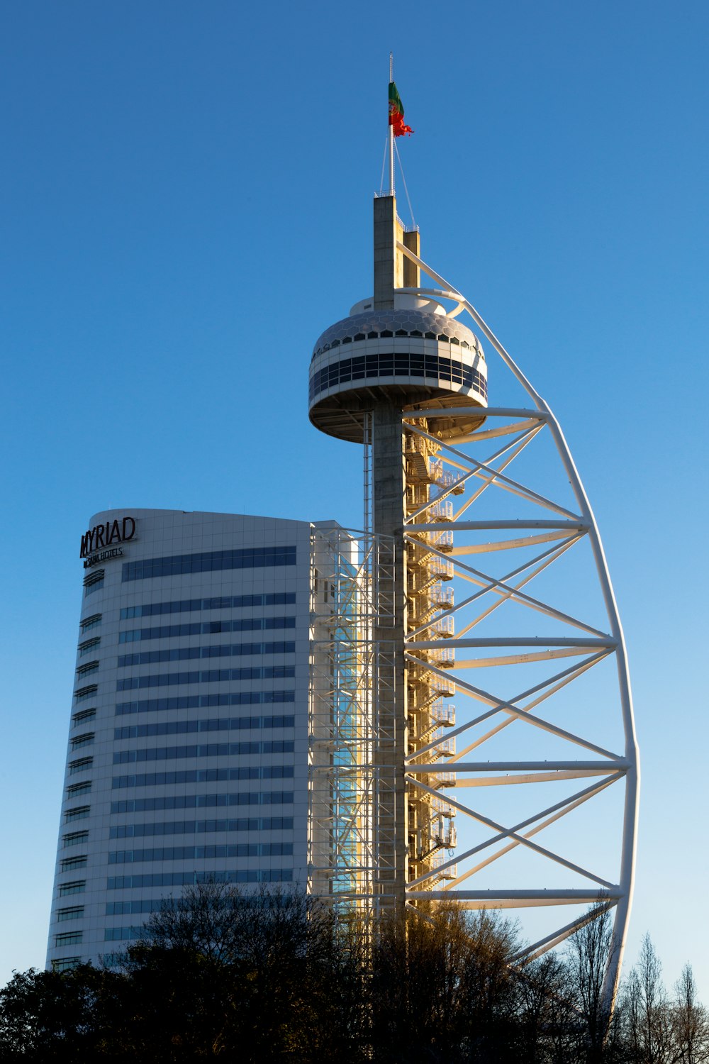 a tall tower with a flag on top of it