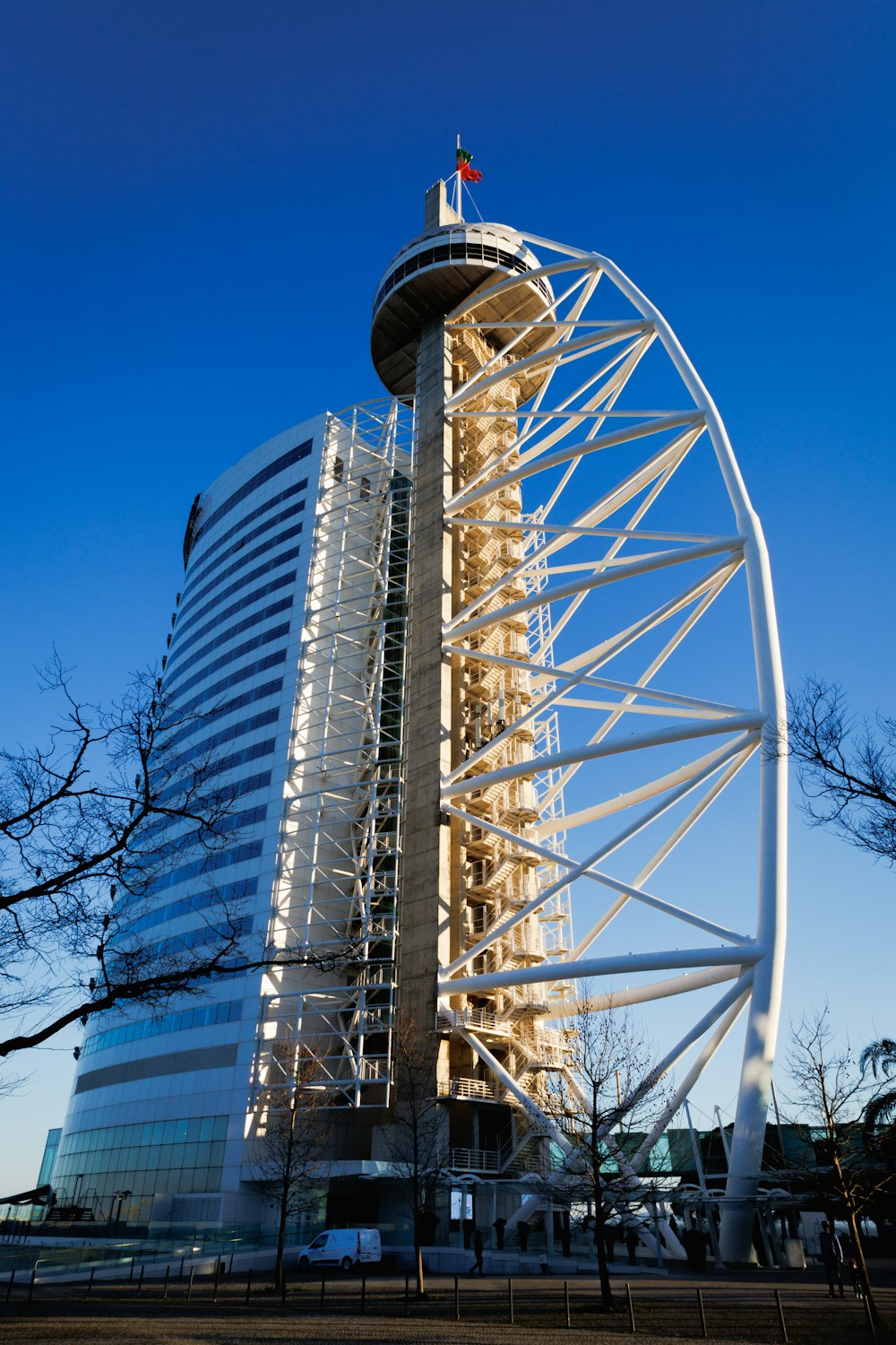 a tall building with a large metal structure on top of it