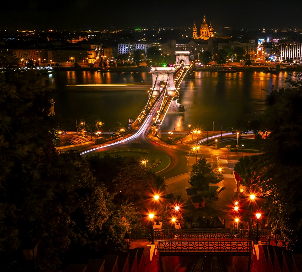 a night time view of a city with a bridge