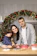 A cozy family kitchen scene with kids and parent laughing around the table.