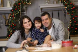A happy family gathered around a table with various Voltaris appliances in use.