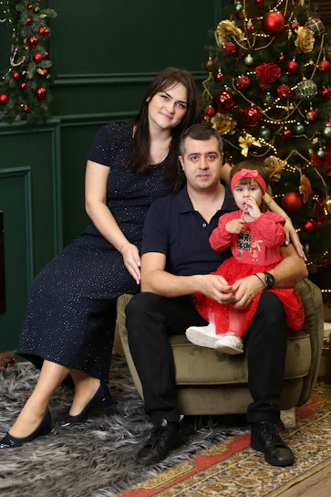 A warm family gathering in a cozy room with navy blue and gold accents symbolizing faith and unity.