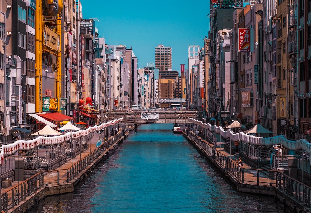 a river running through a city next to tall buildings