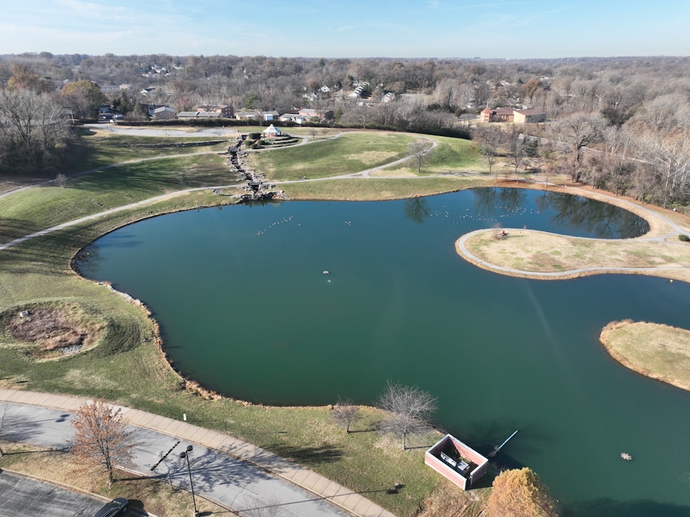 an aerial view of a lake surrounded by a park