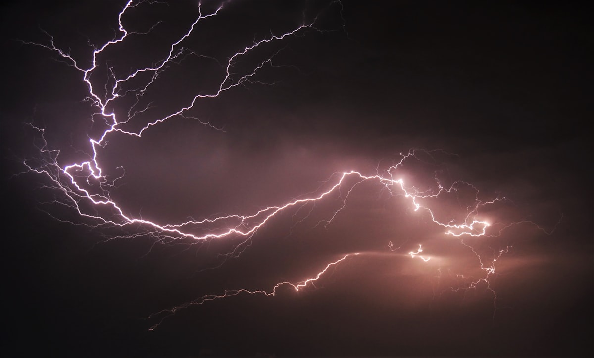 Lightning strikes in a dark night sky during a summer thunderstorm