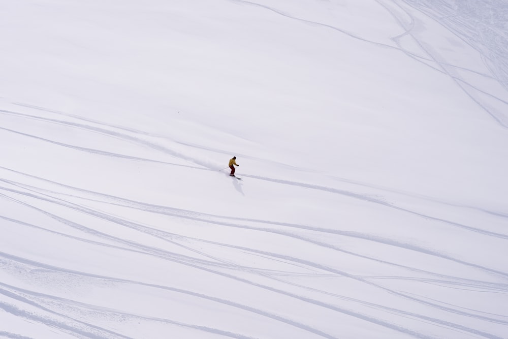 a person skiing down a snow covered slope