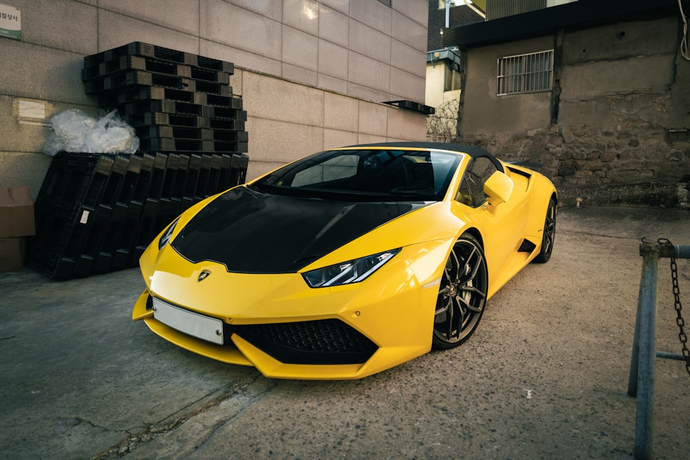 a yellow sports car parked in front of a building