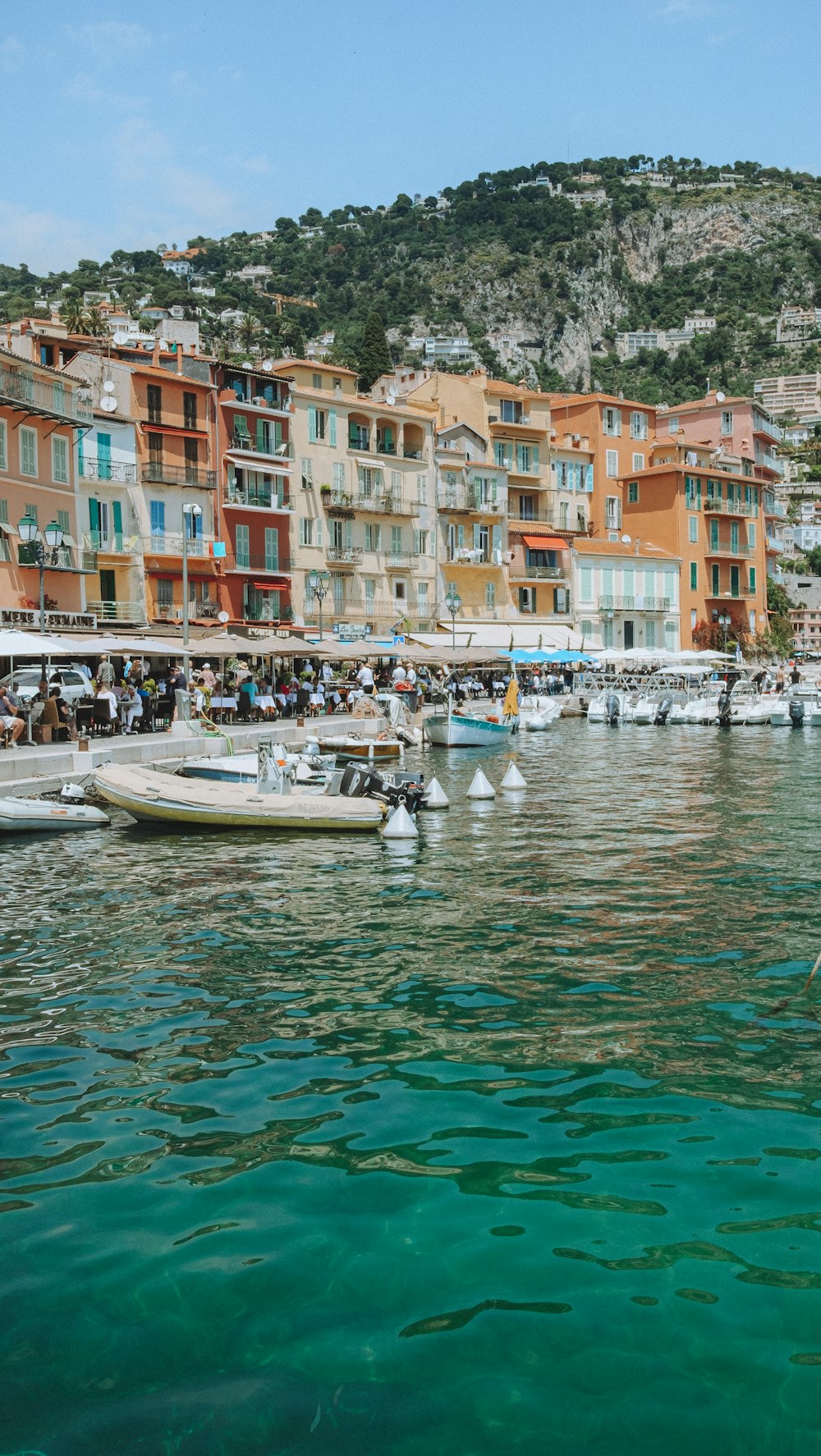 a group of boats floating on top of a body of water