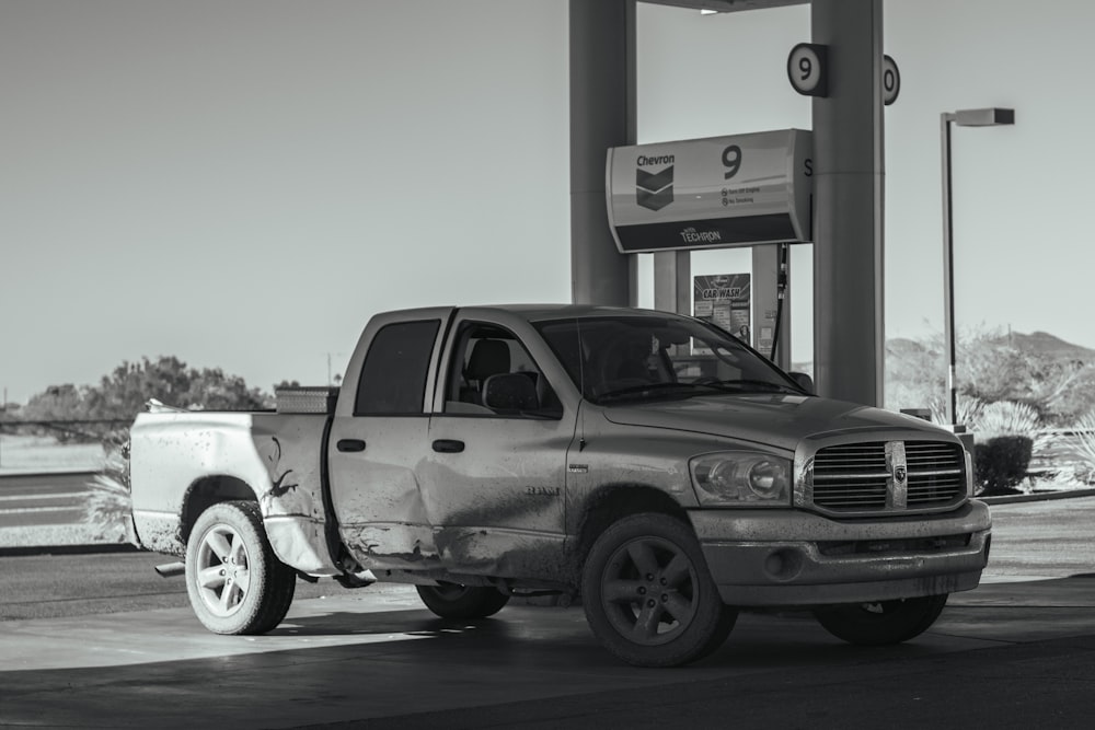 a truck parked in front of a gas station