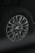 Forged alloy wheels and suspension components displayed on a heavy-duty off-road vehicle