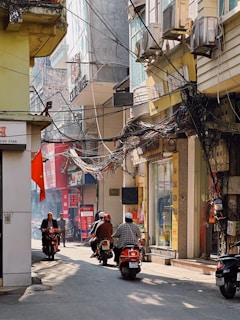 A close-up of a motorbike weaving through congested traffic.