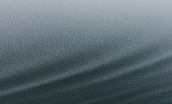 A calm body of water with gentle ripples creating a serene and peaceful surface.
