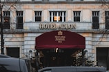a hotel with a red awning in front of it