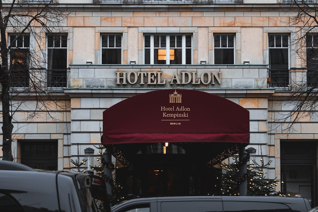 a hotel with a red awning in front of it,