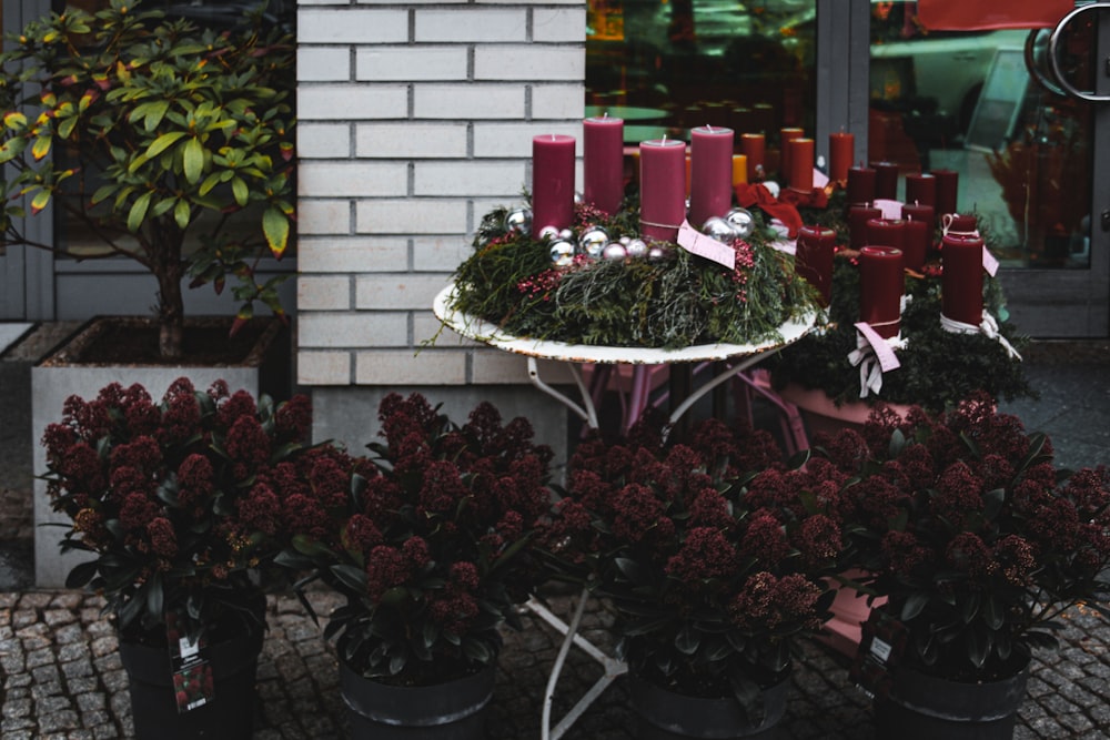 a display of flowers and candles in front of a building
