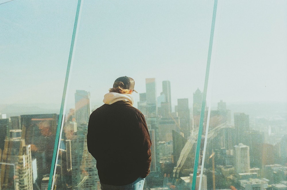 a man standing on top of a tall building