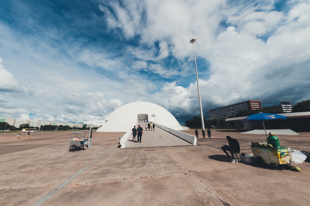 a group of people standing on top of an airport tarmac