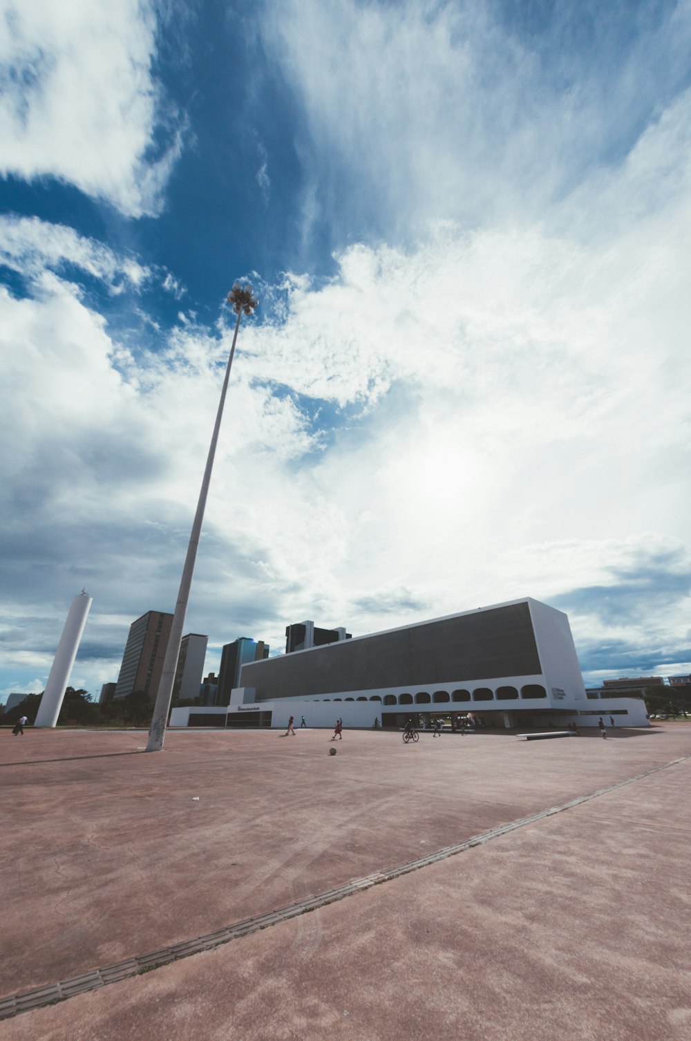 a large building with a tall pole in front of it