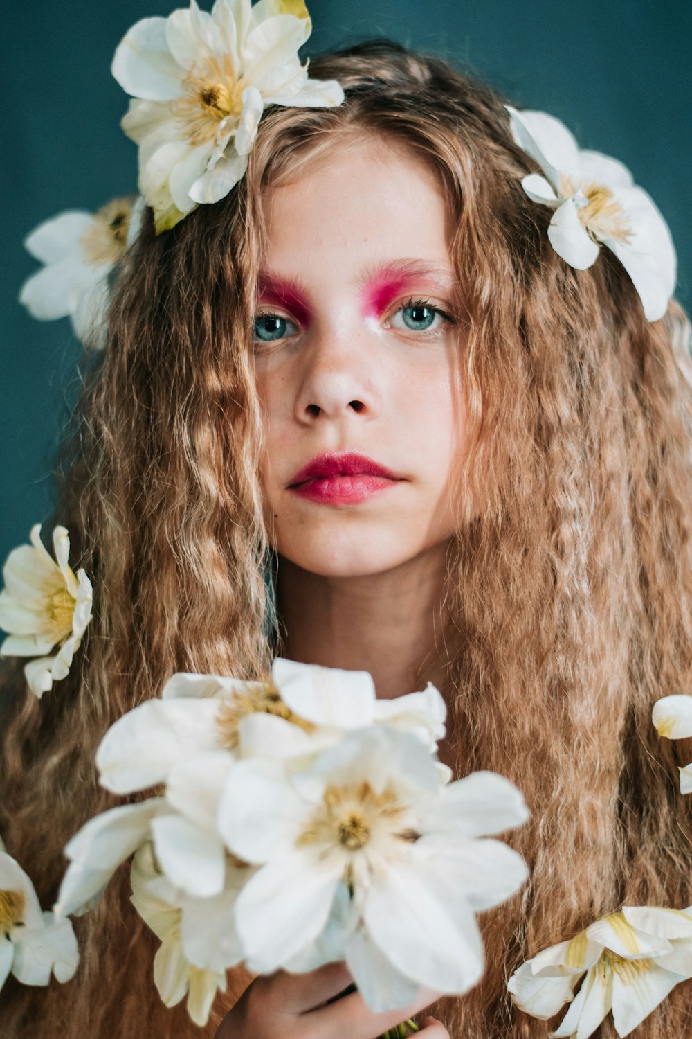 a woman with long hair and flowers in her hair