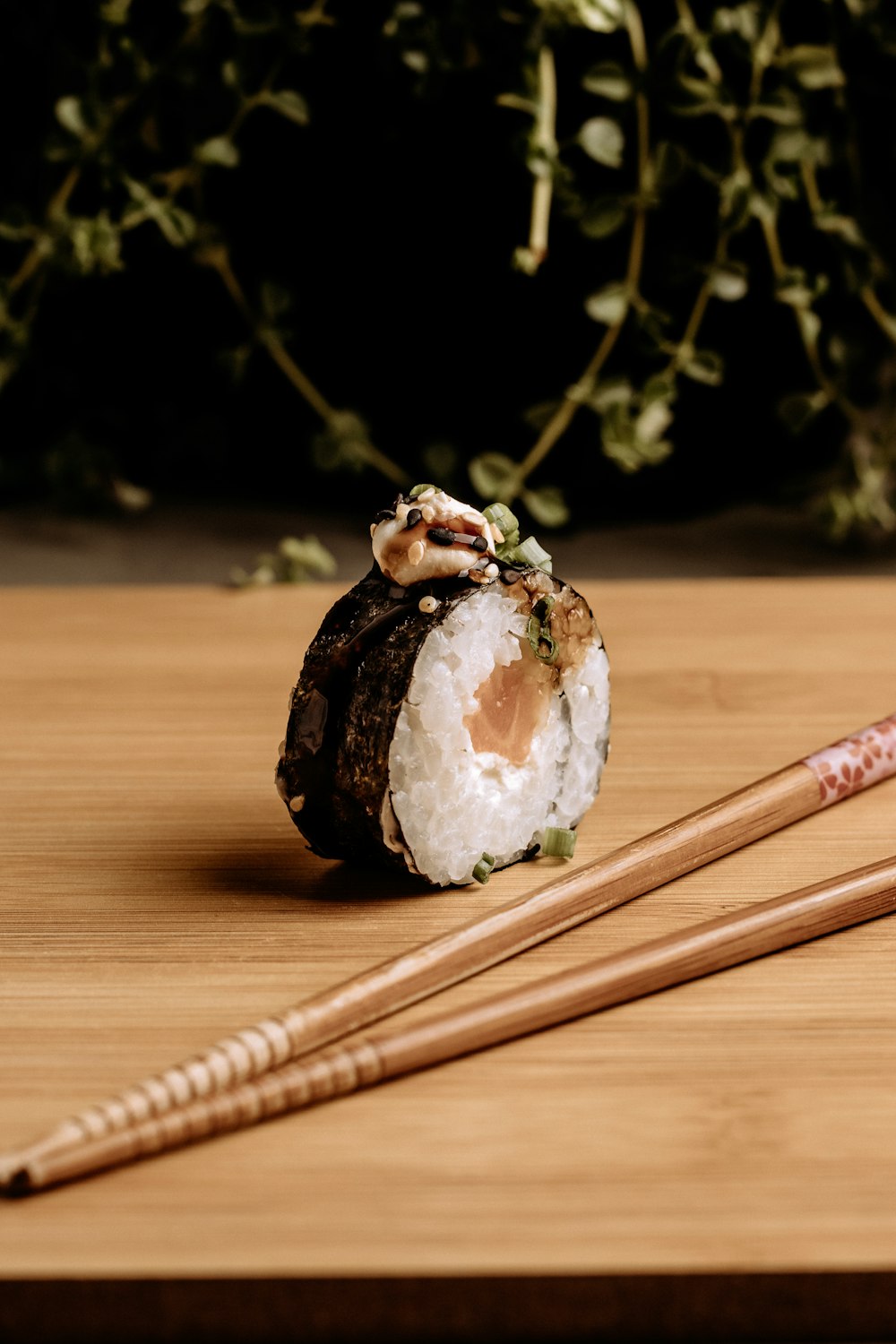 two chopsticks and a sushi on a table