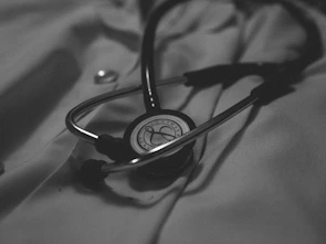 a black and white photo of a stethoscope on a bed