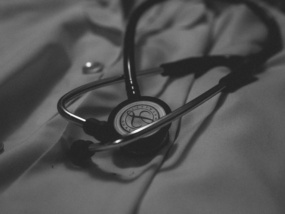 a black and white photo of a stethoscope on a bed