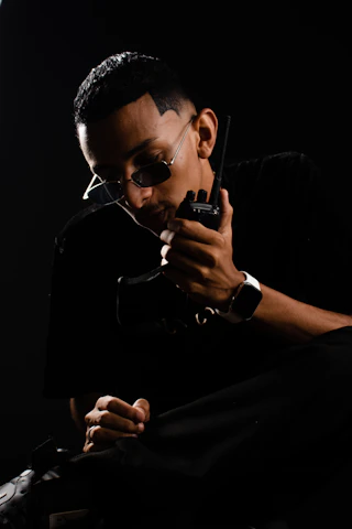 a man holding a gun in his right hand