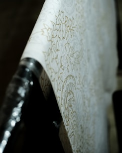 Close-up of a skilled installer applying textured wallpaper with precision.