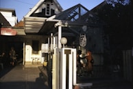 An outdoor meetup with creators chatting and exchanging ideas over coffee in a sunny courtyard.